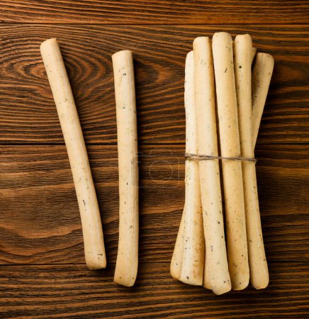 Grissini, bread sticks close-up on a wooden background. Top view