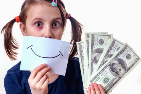 Conceptual photography: money isn't happiness. Beautiful young girl with banner with fake smile and US Dollar bills. Horizontal image.