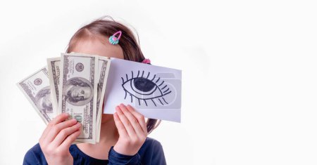 Conceptual image of young girl holding US Dollar money and banner with open eye as symbol: money can buy happiness. Copy space.