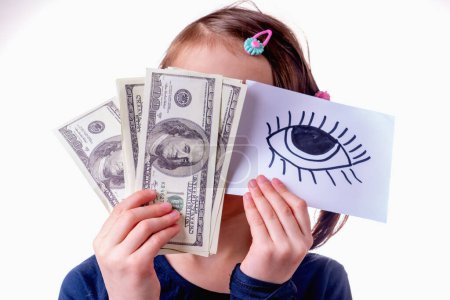 Conceptual image of young girl holding US Dollar money and banner with open eye as symbol: money can buy happiness