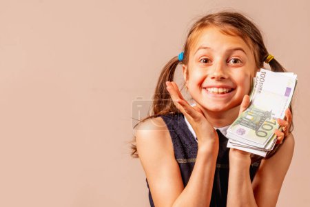 Young pretty and very happy girl with Euro money. Copy space for text or design.