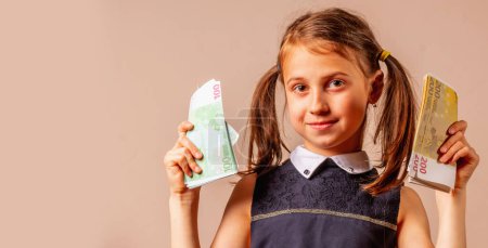 Young beautiful happy girl sniffs Euro bills money. Copy space for text or design.