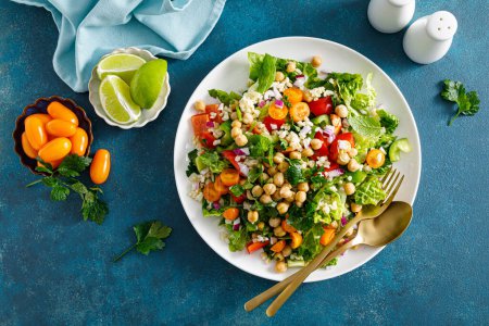 Photo for Tabbouleh salad. Tabouli salad with fresh parsley, onions, tomatoes, bulgur and chickpea. Healthy vegetarian food, diet. Top view - Royalty Free Image