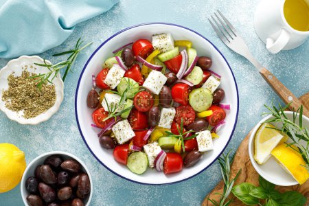 Photo for Greek salad. Vegetable salad with feta cheese, tomato, olives, cucumber, red onion and olive oil. Healthy vegetarian mediterranean diet food. Top view - Royalty Free Image