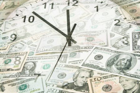 Photo for Clock on assorted American banknotes. Time is money idea - Royalty Free Image