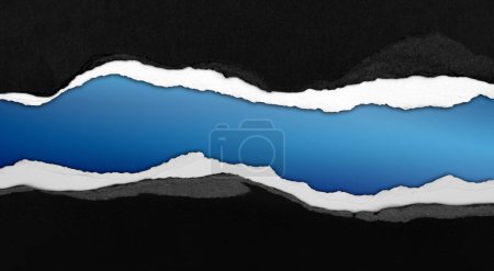 Foto de Papel negro rasgado sobre fondo azul, espacio para copia - Imagen libre de derechos