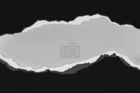 Photo for Ripped black paper on grey background. Copy space - Royalty Free Image