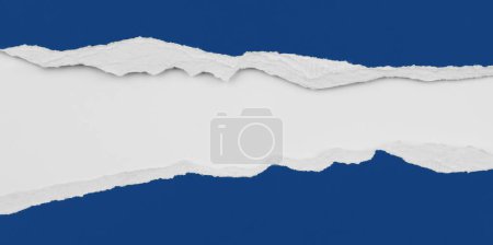 Photo for Hole ripped in blue paper - Royalty Free Image