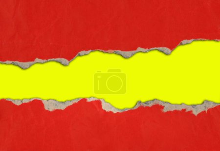 Photo for Hole ripped in red paper on yellow background - Royalty Free Image