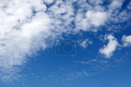 Photo for Fluffy white clouds in a blue sky - Royalty Free Image