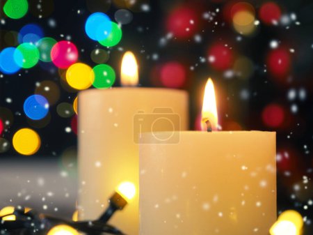 Two burning Advent candles with blurred Christmas lights, beautiful romantic Christmas background