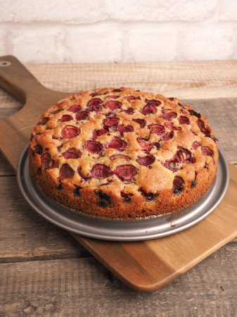 Photo for Tasty organic cherry cake on a rustic wooden kitchen table, healthy sweet food, homemade bakery - Royalty Free Image