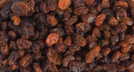 Raisins secs biologiques savoureux, gros plan, image de texture en utilisant comme arrière-plan ou en-tête, aliments alcalins sains
