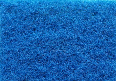 Texture of a blue plastic fiber sponge, environmentally harmful products concept
