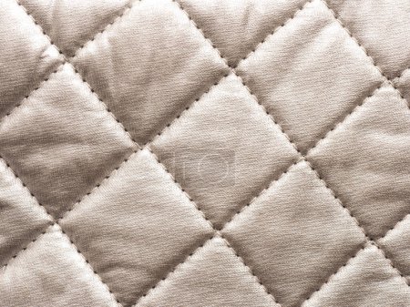 Close up of a texture of aluminum layered quilted fabric using as background