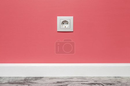 Photo for White outlet installed on the pink wall, front view. - Royalty Free Image