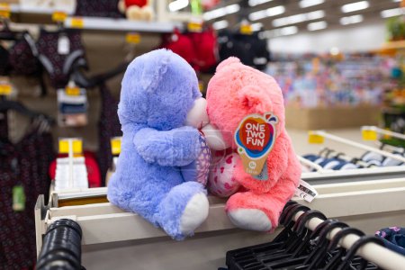 Photo for Colorful plush teddy bears displayed in a store, with a focus on one pink and one blue bear embracing. - Royalty Free Image