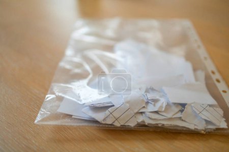 Téléchargez les photos : Documents en papier déchiqueté dans une poche perforée en plastique, concept d'accords rompus. - en image libre de droit