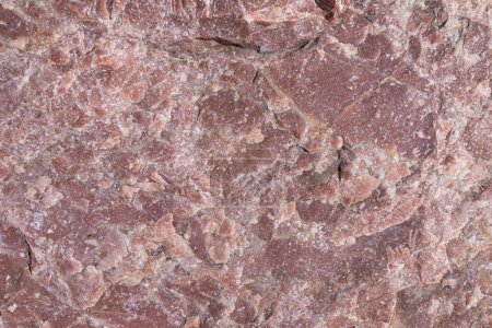 Pink marble surface showcasing intricate patterns and textures, ideal for interior design and decorative purposes.