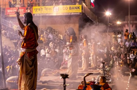 Photo for Varanasi, India - 01 October 2014: A Hindu priest performs the Ganga Aarti ritual during Varanasi Fire puja is a Hindu ritual that takes place at Dashashwamedh Ghat on the banks of the river Ganges - Royalty Free Image