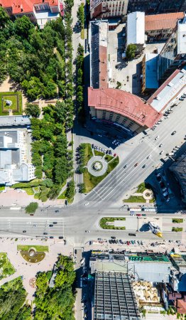 Photo for Aerial city view with crossroads, roads, houses, buildings, parks and parking lots. Copter drone helicopter shot. Panoramic wide angle image. - Royalty Free Image