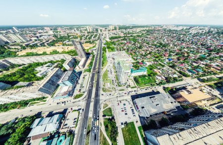 Photo for Aerial city view with crossroads and roads, houses, buildings, parks and parking lots, bridges. Helicopter drone shot. Wide Panoramic image. - Royalty Free Image