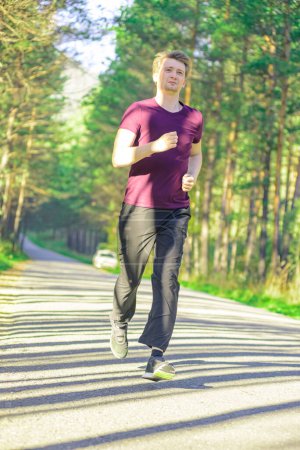 Photo for Running man jogging in city park at beautiful summer day. Sport fitness model caucasian ethnicity training outdoor. - Royalty Free Image