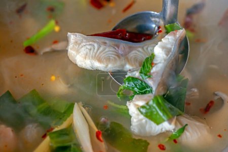 Photo for Asian redtail catfish in clear tomyum soup (thai fish soup) - Royalty Free Image