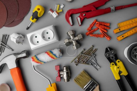 Photo for Household hardware items. home improvement and repair tools on gray background. top view - Royalty Free Image