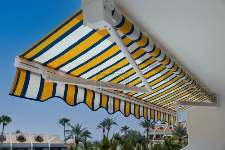 Photo for Retractable manual awning above apartment balcony - Royalty Free Image