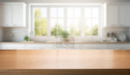 Foto de Mostrador de madera marrón vacío para la exhibición del producto en fondo interior borroso blanco de la cocina del hogar - Imagen libre de derechos