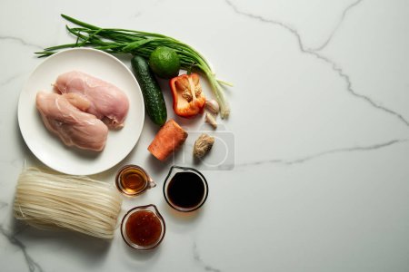 Photo for Healthy Thai chicken noodle salad ingredients list. Aisan cuisine. Rice noodles with chicken and vegetables and sauce based on soy, fish and sweet chilli sauce with garlic and ginger plus sugar. High - Royalty Free Image