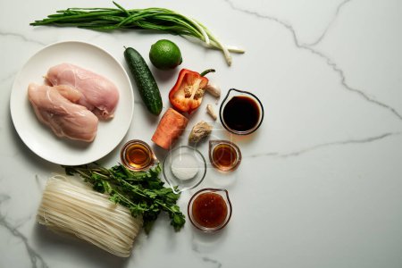 Photo for Healthy Thai chicken noodle salad ingredients list. Aisan cuisine. Rice noodles with chicken and vegetables and sauce based on soy, fish and sweet chilli sauce with garlic and ginger plus sugar. High - Royalty Free Image