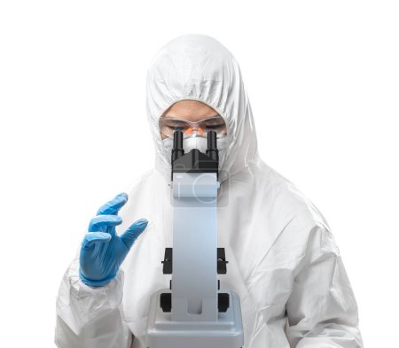Photo for Worker wears medical protective suit or white coverall suit with mask and goggles look through microscope isolated on white background - Royalty Free Image