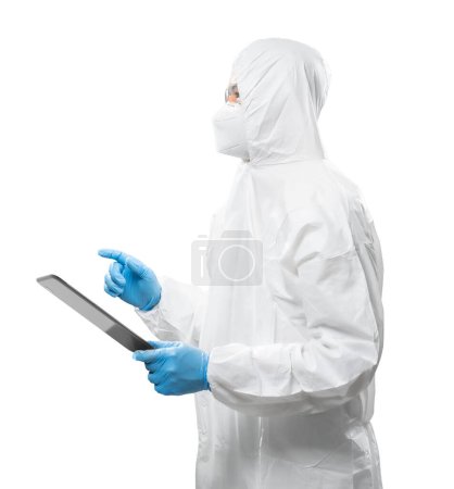 Photo for Worker wears medical protective suit or white coverall suit with mask and goggles hold digital tablet isolated on white background - Royalty Free Image
