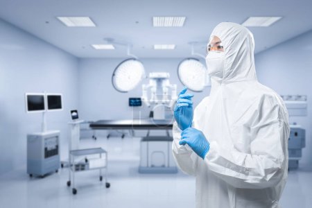 Photo for Doctor wears medical protective suit or white coverall suit in surgery room - Royalty Free Image