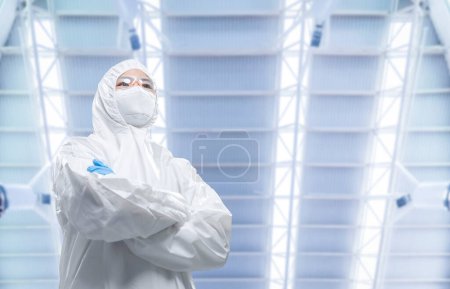 Photo for Worker or engineer wears protective suit or white coverall suit work in semiconductor manufacturing factory - Royalty Free Image