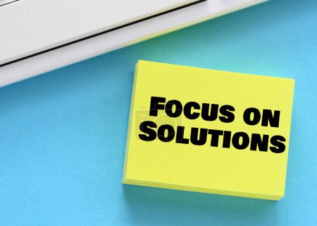 Photo for Focus on solutions words on a small sheet of paper. - Royalty Free Image