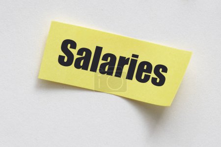 Photo for SALARIES Concept. The word SALARIES on a small sheet in an office notebook. - Royalty Free Image