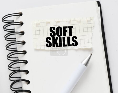 SOFT SKILLS on a piece of paper placed on the notebook. Concept for business.