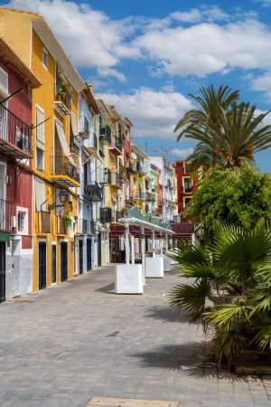 Photo for Villajoyosa street with multi-colored houses. Villajoyosa a coastal town in Alicante Province, Valencian Community, Spain, by Mediterranean Sea - Royalty Free Image
