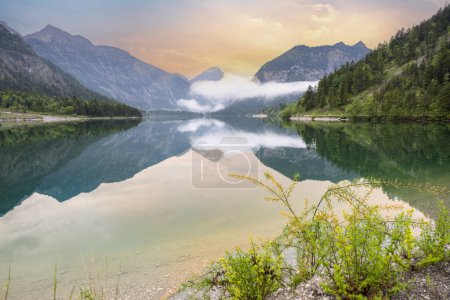 Lake Plansee in Austria Tirol in the evening with fog.