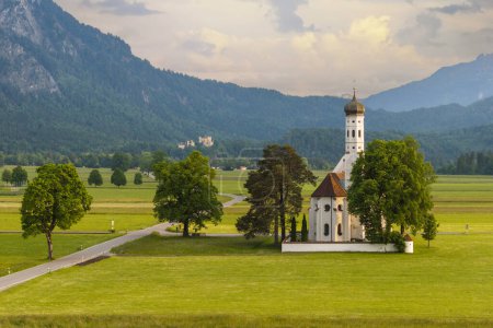 Beautiful view of the Saint Coloman church near the Neuschwanstein castle, against the backdrop of the beautiful mountains, Schwangau in the Bavarian province of Germany