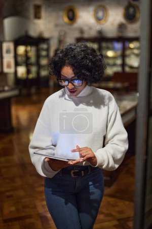 Photo for Woman visitor in the historical museum looking at art object. - Royalty Free Image