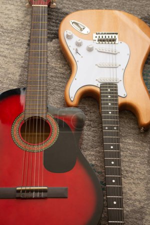 Foto de Beautiful picture of classic and electric guitars on a grey background - Imagen libre de derechos