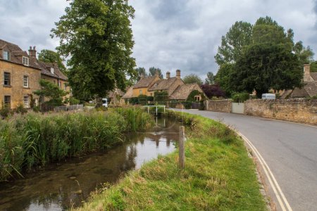 Photo for A village road in The Slaughters in the Cotswolds in England - Royalty Free Image