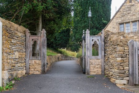 Photo for Old Wooden gate entrance to an old English Church in the Cotswolds - Royalty Free Image