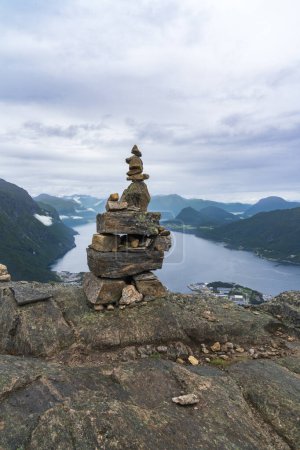A cairn stack of stones and view from hiking Rampestreken and Nesaksla in Andalsnes in Norway