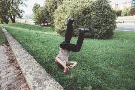 Photo for Acrobatic sportive fit man doing parkour trick outdoors park - Royalty Free Image