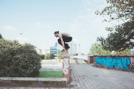 Photo for Athletic acrobatic man doing parkour trick training outdoors - Royalty Free Image